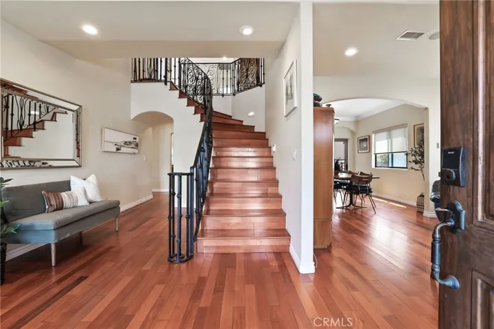 Welcome home! Enjoy the Hardwood floors, sweeping staircase, decorative rod iron banister at first glance.