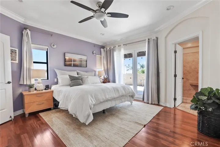 The primary suite features access to the balcony patio and large en suite bathroom.