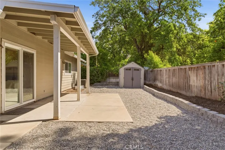 Covered patio with access to living area and primary bedroom. Storage shed included too!