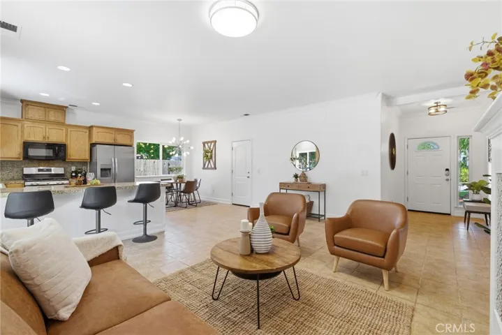 Living area is open to entry, kitchen and dining areas.