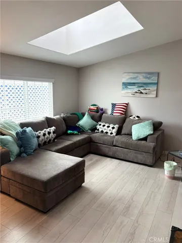 Large livingroom with skylight. Vaulted ceiling