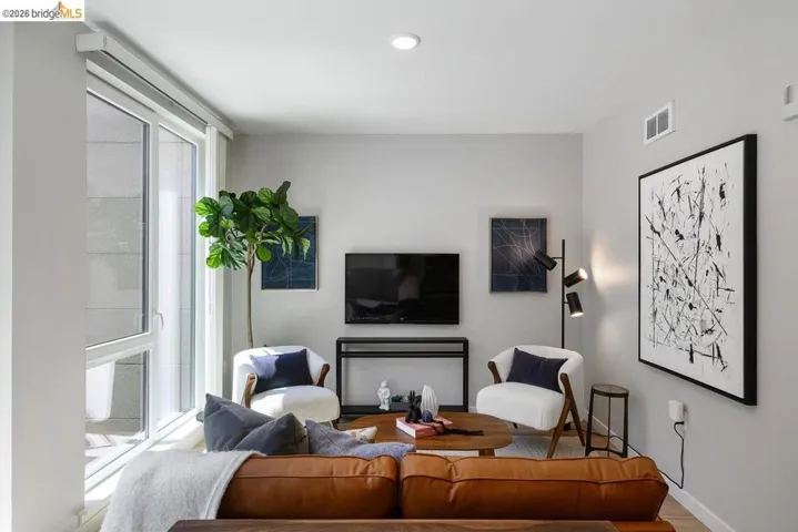 Living room with wood finished floors and recessed lighting