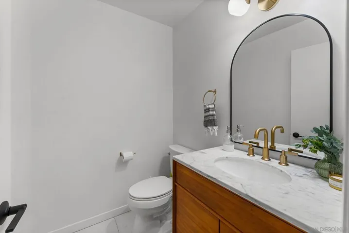 Updated mid-century powder room downstairs with designer West Elm vanity.