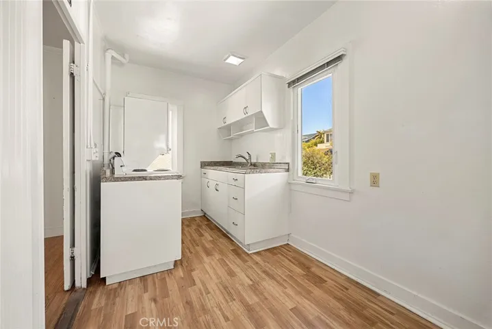 cottage kitchen with stackable washer and dryer