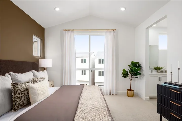 Model home primary bedroom with vaulted ceiling