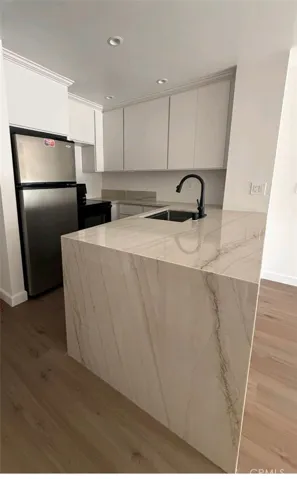 Newly built kitchen with quartzite, waterfall countertop