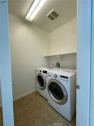 laundry room located in the hallway of  the second floor