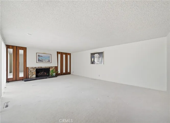 Living room with fireplace and view of the pool