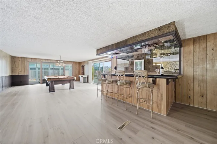 Pool table, wet bar and new luxury vinyl flooring ready for entertaining