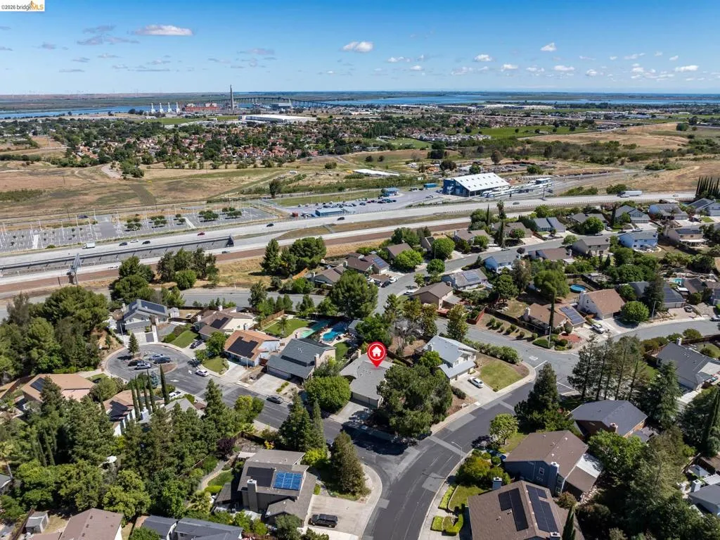 Residential neighborhood with mature trees, established homes, and proximity to highway infrastructure