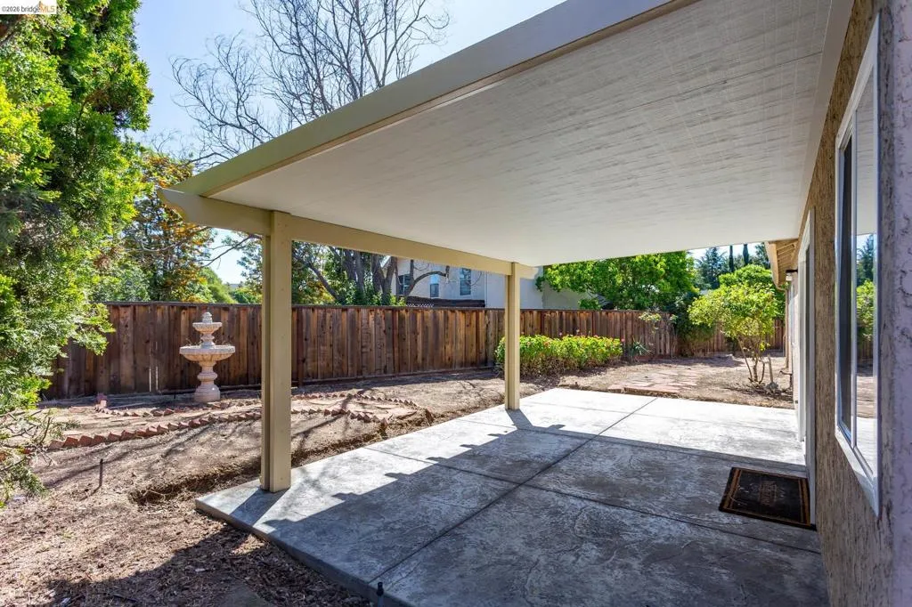Covered patio featuring an imprinted concrete surface