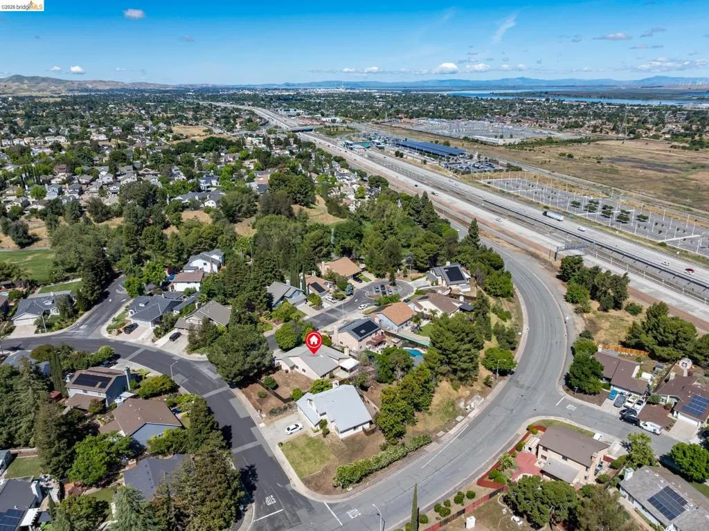 Aerial perspective showcasing a residential neighborhood with varied architectural styles and mature trees