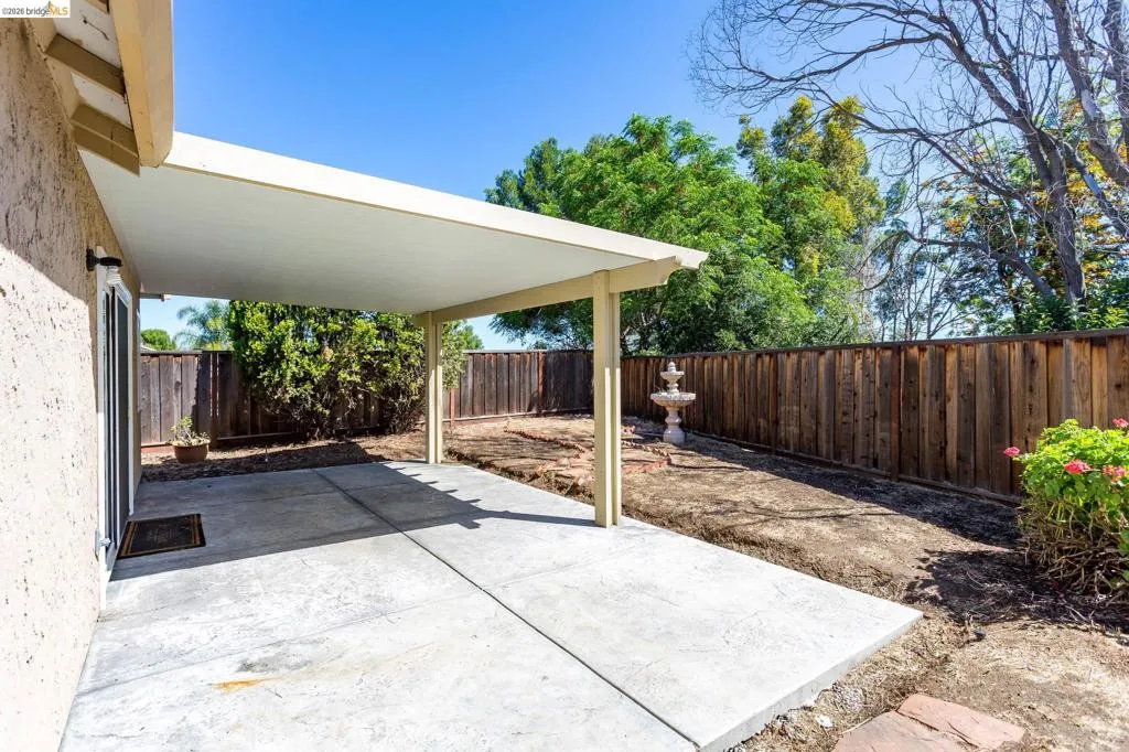 Expansive concrete patio with an attached covered awning
