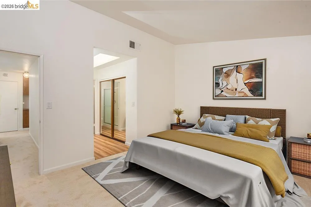 Carpeted flooring in a spacious room featuring a neutral color palette
