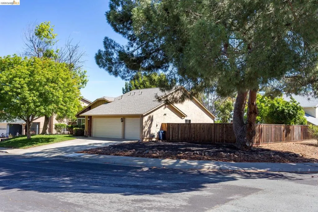 Single-story residence featuring a two-car garage, stucco exterior, and a shingle roof