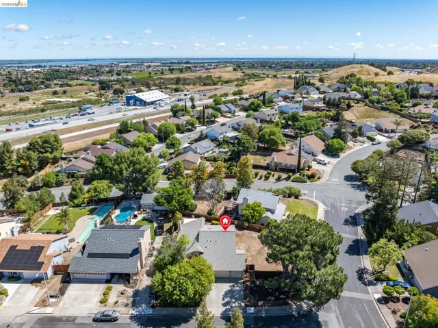 Aerial view of a residential neighborhood with varied architectural styles and mature landscaping
