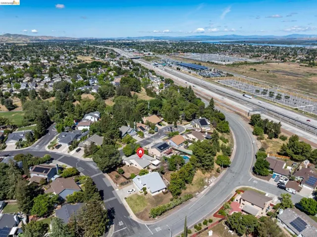 Aerial perspective showcasing a residential neighborhood with varied architectural styles and mature trees