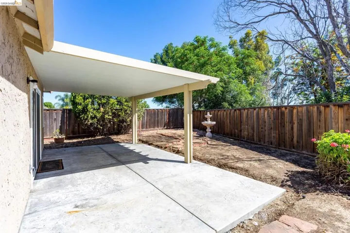Expansive concrete patio with an attached covered awning