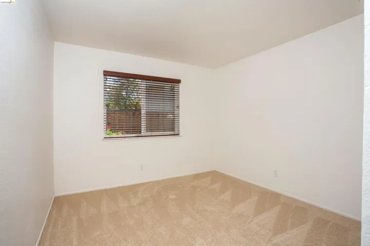 Neutral-toned carpeting and light-colored walls create a versatile interior space