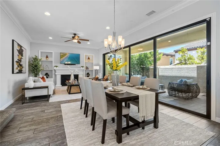 Living / Dining area epitomizes seamless California indoor outdoor living with massive full wall sliders 2 and matching tile flooring giving you access to the large California room with water feature 2
