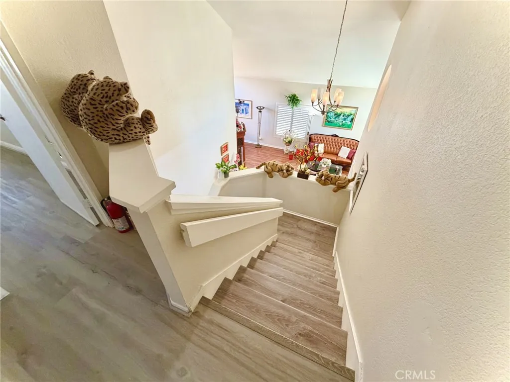 Staircase with wood flooring throughout.