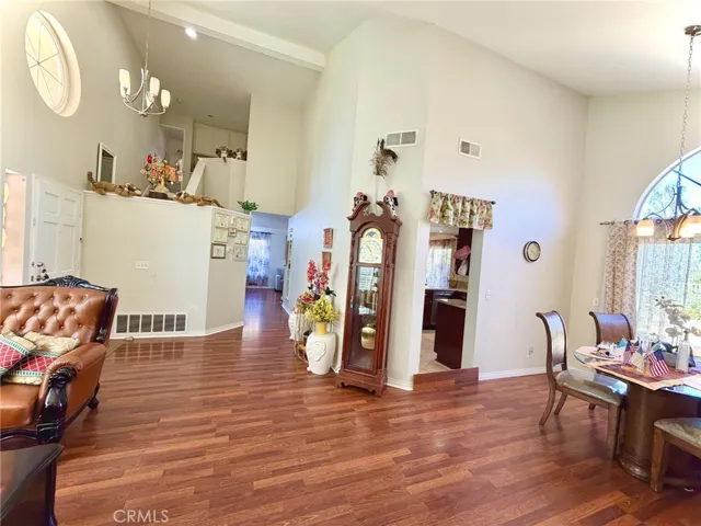 Well-kept interior with high ceilings, wood flooring, and open living and dining areas.
