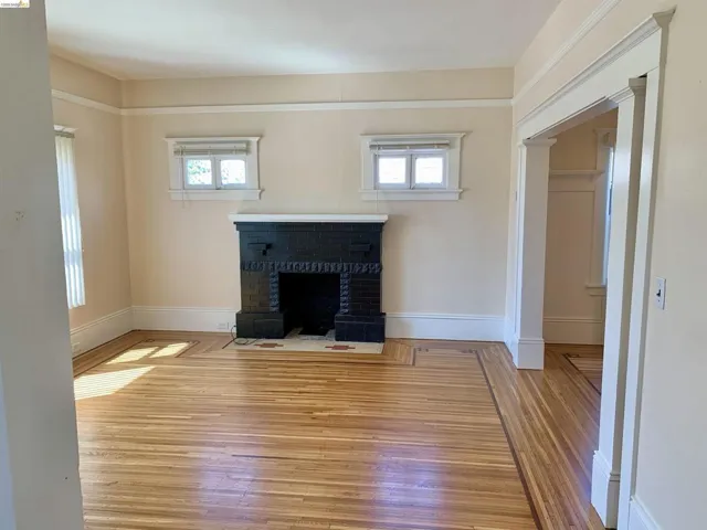 Unfurnished living room featuring hardwood / wood-style flooring and a fireplace