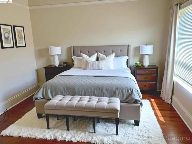 Bedroom with wood finished floors and crown molding