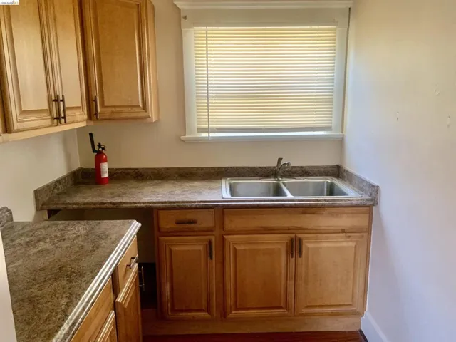 Kitchen featuring dark countertops and brown cabinetry