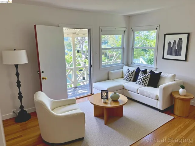 Living area with baseboards and wood finished floors