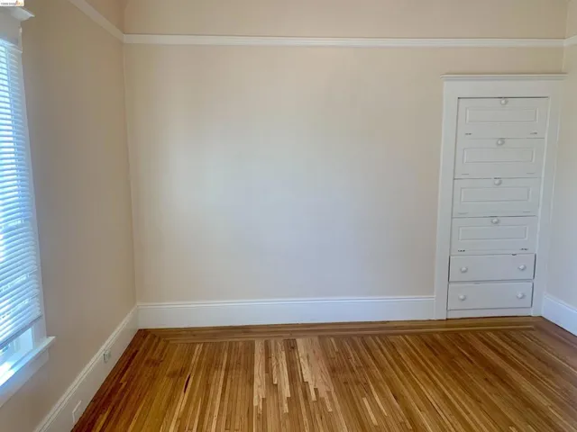 Empty room with baseboards and wood finished floors