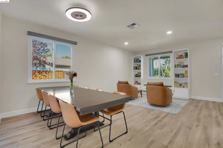 Spacious interior featuring light wood-finish flooring, recessed lighting, and a modern ceiling fixture