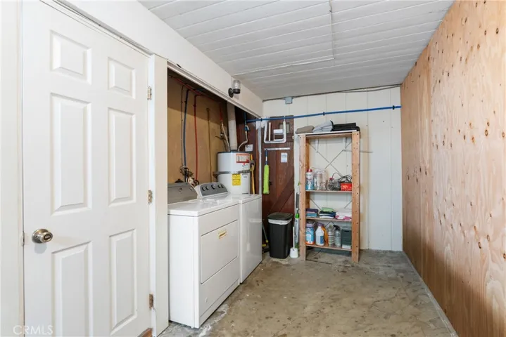 laundry room in front area of garage with access into the house and backyard