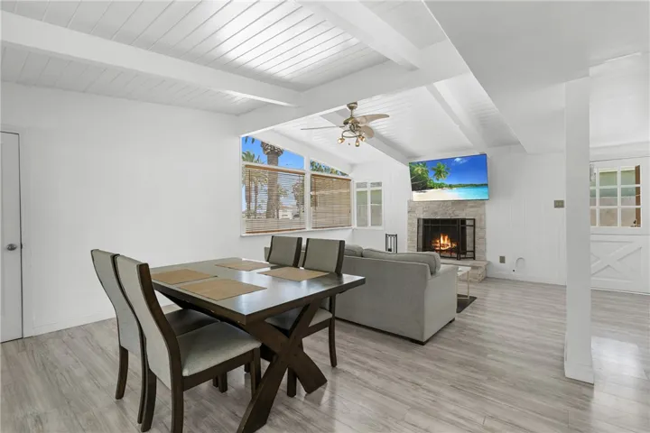 open living and dining space with gas fireplace