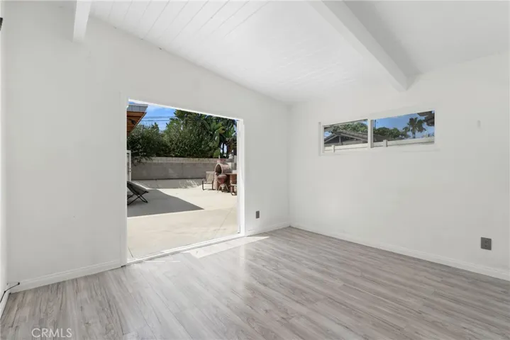 bedroom two with french doors that open to back patio