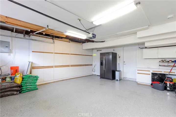 Clean, epoxy-finished garage with extensive built-in storage