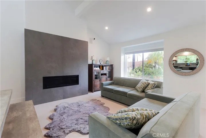 Contemporary living room featuring a sleek modern fireplace and high ceilings.