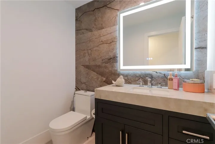 Designer powder room with modern finishes and statement stone wall