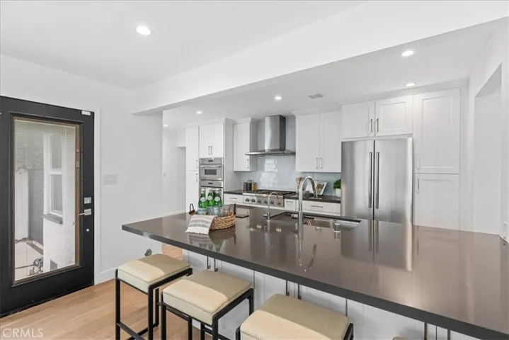 Open floorplan kitchen with island and Thermador appliances