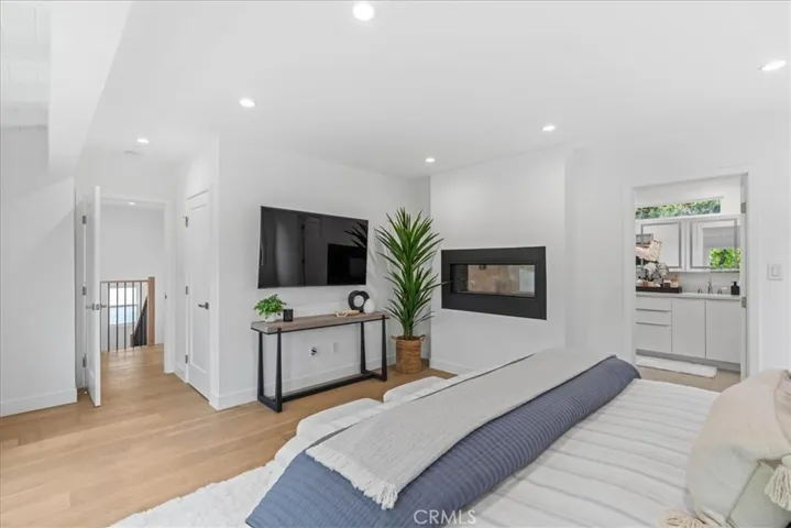 Primary Bedroom with walk-in closet and double-sided fireplace