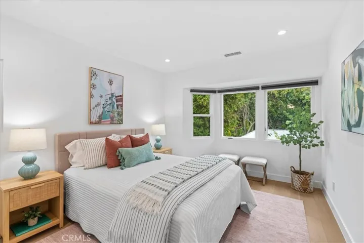 Bedroom 2 with windows over looking the vine covered patio and backyard lawn