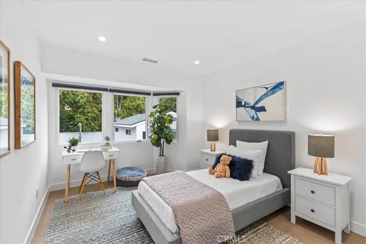 Bedroom 3 with windows over looking the backyard lawn