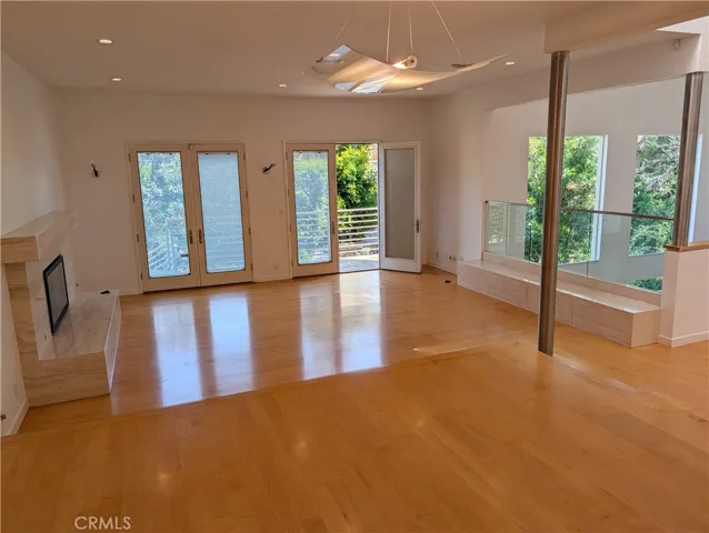View to living room with fireplace and balcony