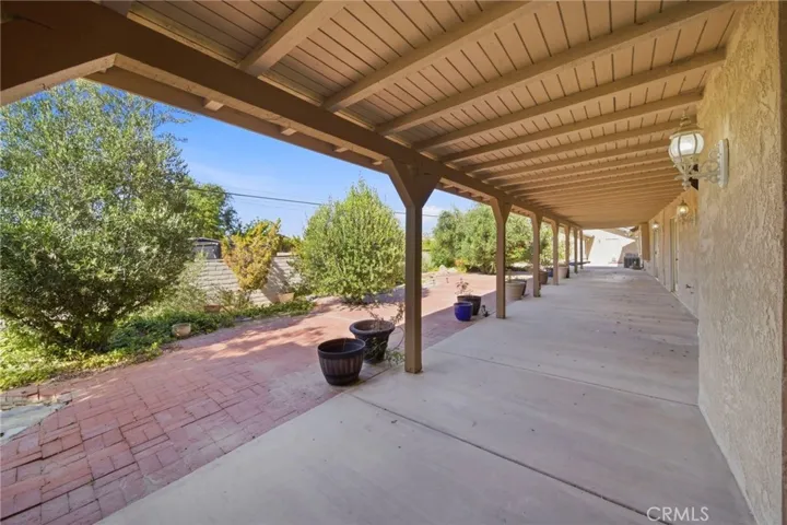 Fully Covered Patio looking toward the Back Garden and 4 car Garage