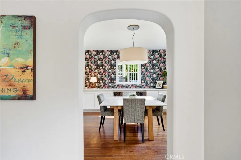 Arched opening from the family room into this elegant dining room.