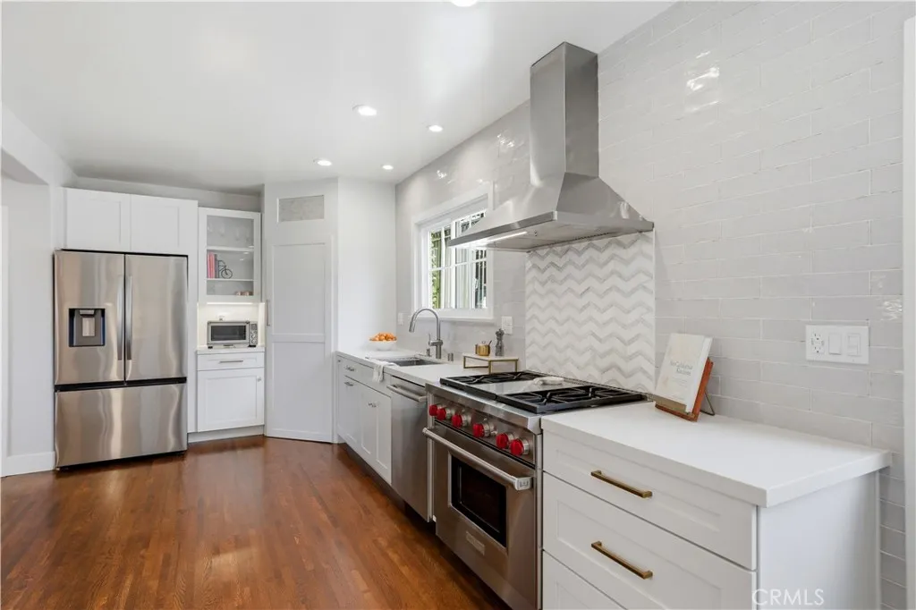 A wonderful, walk-in pantry is hidden behind the corner cabinet.