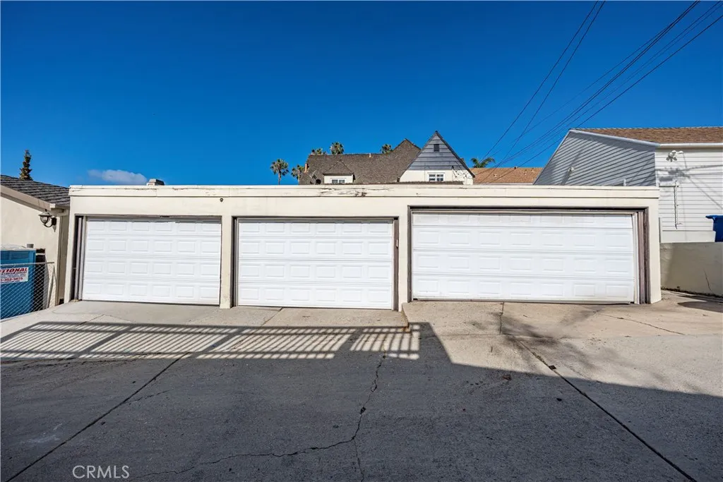 Garages for four cars with parking in front for another two.