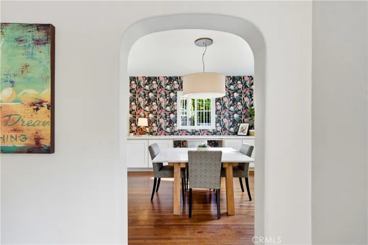 Arched opening from the family room into this elegant dining room.