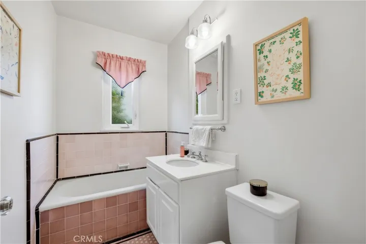 Pretty in pink bathroom is located on the first floor.