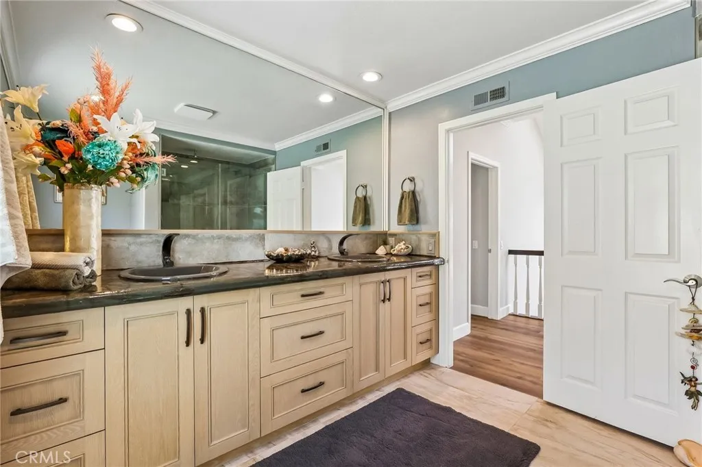 Double sinks, custom cabinets, shower in tub